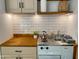Efficient kitchenette with stainless steel appliances, light wood cabinets, and butcher block countertop at 16545 E Gunsight Dr # 103, Fountain Hills, AZ 85268