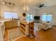 Open-concept living room showcases tile floors, a kitchen island, a dining area and a comfortable seating area at 16545 E Gunsight Dr # 103, Fountain Hills, AZ 85268