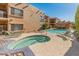 Beautiful pool area with lounge chairs, a hot tub, and well-maintained landscaping at 16545 E Gunsight Dr # 103, Fountain Hills, AZ 85268