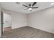 Bright bedroom with ceiling fan, door, neutral paint and stylish wood-look flooring at 18003 N 135Th Dr, Sun City West, AZ 85375