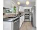 Modern kitchen with stainless steel appliances, white cabinetry, and a window that offers lots of natural light at 1825 E Kings Ave, Phoenix, AZ 85022