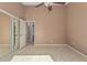 Bedroom with a mirrored closet, tiled floor, neutral walls, and a ceiling fan at 1841 E Kings Ave, Phoenix, AZ 85022