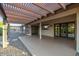 Covered patio area with a latticed pergola, providing shade and an outdoor living space at 18424 N 137Th Dr, Sun City West, AZ 85375