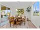 Dining area features a wood table with chairs, backyard views, and backyard pool access at 19266 E Apricot Ln, Queen Creek, AZ 85142