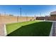 An expansive backyard space with artificial turf for easy maintenance and year-round enjoyment at 20236 W Madison St, Buckeye, AZ 85396