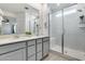 This bathroom boasts dual sinks and a subway tile shower with a glass door at 20236 W Madison St, Buckeye, AZ 85396