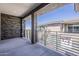 Covered balcony showcases stone accents and overlooks neighboring homes, offering a private outdoor retreat at 2121 W Sonoran Desert Dr # 45, Phoenix, AZ 85085