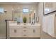 Modern bathroom with double sinks, white cabinets, a glass-enclosed shower, and neutral finishes at 2121 W Sonoran Desert Dr # 45, Phoenix, AZ 85085
