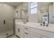Modern bathroom showcasing double sinks, a large mirror, and a glass-enclosed shower with tile surround at 2121 W Sonoran Desert Dr # 45, Phoenix, AZ 85085
