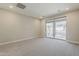 Bright bedroom featuring neutral walls, plush carpeting, and sliding glass doors to a private balcony at 2121 W Sonoran Desert Dr # 45, Phoenix, AZ 85085