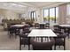 Well-lit dining area with ample seating, modern decor, and large windows overlooking the pool at 2121 W Sonoran Desert Dr # 45, Phoenix, AZ 85085