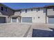 Modern townhome garages featuring gray doors and paver driveways for a sleek curb appeal at 2121 W Sonoran Desert Dr # 45, Phoenix, AZ 85085