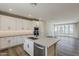 Modern kitchen offers white cabinets, stainless appliances, island with sink, and open floor plan at 2121 W Sonoran Desert Dr # 45, Phoenix, AZ 85085