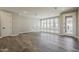 Spacious living room with hardwood floors, large windows providing natural light, and a modern railing at 2121 W Sonoran Desert Dr # 45, Phoenix, AZ 85085