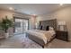 A modern main bedroom suite featuring a plush bed, sliding glass doors, and neutral decor at 2121 W Sonoran Desert Dr # 45, Phoenix, AZ 85085