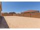 Large backyard featuring block wall and dirt, awaiting landscaping and customization at 21640 E Roundup Way, Queen Creek, AZ 85142