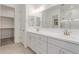 Bright bathroom features double sinks and white cabinetry at 21640 E Roundup Way, Queen Creek, AZ 85142
