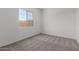 Bedroom featuring neutral carpet, one window, and white walls at 21640 E Roundup Way, Queen Creek, AZ 85142