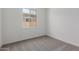 Bedroom with carpeted floors and a large window at 21640 E Roundup Way, Queen Creek, AZ 85142