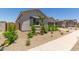 Charming home exterior with landscaped front yard and beautiful architectural details at 21640 E Roundup Way, Queen Creek, AZ 85142