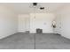 Spacious two-car garage featuring a concrete floor, white walls and two access doors at 21640 E Roundup Way, Queen Creek, AZ 85142
