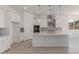Bright open concept kitchen with a large island, stainless steel appliances, and modern pendant lights at 21640 E Roundup Way, Queen Creek, AZ 85142