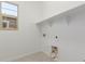 Bright laundry room with a window and built-in shelf at 21640 E Roundup Way, Queen Creek, AZ 85142