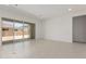 Bright, open-concept living room featuring sliding glass doors to back yard at 21640 E Roundup Way, Queen Creek, AZ 85142