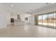 Open-concept living room with sliding doors to backyard and view of kitchen at 21640 E Roundup Way, Queen Creek, AZ 85142