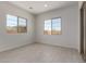 Bright room featuring tile flooring and two windows with natural light at 21640 E Roundup Way, Queen Creek, AZ 85142