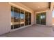 Covered patio with large sliding glass doors, offering a seamless transition to the backyard at 21640 E Roundup Way, Queen Creek, AZ 85142