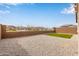 Spacious backyard showing the gravel landscaping and surrounding block wall for privacy at 2235 W Park St, Phoenix, AZ 85041
