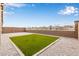 The backyard features artificial grass with gravel all around at 2235 W Park St, Phoenix, AZ 85041