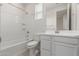 Bright bathroom featuring a shower-tub combo, and vanity with storage cabinet at 2235 W Park St, Phoenix, AZ 85041