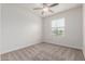 Bright bedroom featuring a ceiling fan, neutral carpet and a window with blinds at 2235 W Park St, Phoenix, AZ 85041