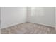 Bright bedroom with carpet flooring, neutral paint, and a window with blinds at 2235 W Park St, Phoenix, AZ 85041