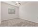This bedroom features neutral carpet, and a window with blinds for natural lighting at 2235 W Park St, Phoenix, AZ 85041