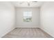 Bright bedroom featuring a window with blinds, carpet flooring, and neutral paint at 2235 W Park St, Phoenix, AZ 85041