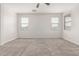 Neutral carpeted bedroom features a ceiling fan and two bright windows at 2235 W Park St, Phoenix, AZ 85041