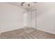 This bedroom features neutral carpet, a ceiling fan, and a closet with sliding doors at 2235 W Park St, Phoenix, AZ 85041