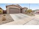 Inviting exterior showcasing a well-manicured lawn and a spacious driveway to the garage at 2235 W Park St, Phoenix, AZ 85041