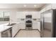 Modern kitchen featuring stainless steel appliances, white cabinetry, and ample counter space at 2235 W Park St, Phoenix, AZ 85041