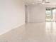 Bright, open living room featuring tile flooring, recessed lighting, and sliding glass doors to the backyard at 2235 W Park St, Phoenix, AZ 85041