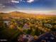Expansive aerial view of lush green spaces, serene ponds, residential areas, and mountain views at 2415 W Hazelhurst Ct, Anthem, AZ 85086
