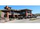 Exterior of clubhouse, with second-story veranda and golf carts parked out front at 2415 W Hazelhurst Ct, Anthem, AZ 85086