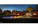 Night view of the community entrance with fountain and mature trees at 2415 W Hazelhurst Ct, Anthem, AZ 85086