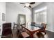 Bright dining room with hardwood floors, modern chandelier, and large windows with white shutters at 2415 W Hazelhurst Ct, Anthem, AZ 85086