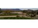 Scenic golf course with sand traps, green fairways and desert vegetation with mountain views in background at 2415 W Hazelhurst Ct, Anthem, AZ 85086