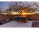Outdoor kitchen with stone countertop, bar seating, and scenic sunset views offers a great entertainment space at 2415 W Hazelhurst Ct, Anthem, AZ 85086