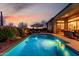 Backyard oasis featuring a sparkling pool, desert landscaping, and cozy seating area, perfect for relaxation and leisure at 2415 W Hazelhurst Ct, Anthem, AZ 85086